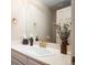 Bright bathroom with ample counter space, and warm accents that elevate the room's design at 7931 W Paine Ave, Lakewood, CO 80235