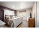 Stylish bedroom featuring a decorative headboard, neutral color palette, and plush bedding, creating a relaxing retreat at 7931 W Paine Ave, Lakewood, CO 80235