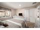 Cozy bedroom with neutral tones, a large window, and a comfortable bed creating a serene and inviting atmosphere at 7931 W Paine Ave, Lakewood, CO 80235