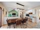 Inviting dining room featuring a rustic wood table, statement lighting, and a built-in desk area at 7931 W Paine Ave, Lakewood, CO 80235