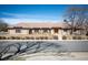 A charming brick home with a tile roof and manicured landscaping at 7931 W Paine Ave, Lakewood, CO 80235