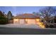 A detached two car garage with brick facade features coach lights and a large driveway at 7931 W Paine Ave, Lakewood, CO 80235