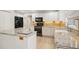 Spacious kitchen featuring granite countertops, white cabinetry, hardwood floors, and stainless steel appliances at 7931 W Paine Ave, Lakewood, CO 80235