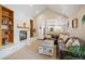 Living room with a fireplace, built-in shelves, and an open view to the kitchen and living areas at 7931 W Paine Ave, Lakewood, CO 80235