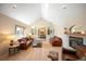 Sunlit living room with vaulted ceilings, hardwood floors, a cozy fireplace, and stylish leather furniture at 7931 W Paine Ave, Lakewood, CO 80235