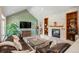 Relaxing living room with vaulted ceiling, stone fireplace, and views of the home's outdoor spaces at 7931 W Paine Ave, Lakewood, CO 80235