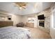 Stylish main bedroom with vaulted ceiling, fireplace, and comfortable seating area at 7931 W Paine Ave, Lakewood, CO 80235