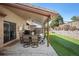 Outdoor patio with a dining set and grill, perfect for entertaining and relaxing, with an expansive artificial turf yard at 7931 W Paine Ave, Lakewood, CO 80235