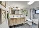 Stylish bathroom featuring a double vanity with a rustic wood finish and modern fixtures at 2096 S Logan St, Denver, CO 80210