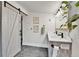 Modern bathroom boasts double sinks, wood accents, and a trendy barn door for a rustic-chic feel at 2096 S Logan St, Denver, CO 80210