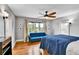 Charming bedroom with hardwood floors, a large window, and a blue sofa for relaxation at 2096 S Logan St, Denver, CO 80210