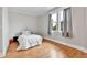 Bedroom offers natural light from the window, with hardwood floors and neutral paint at 2096 S Logan St, Denver, CO 80210