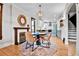 Inviting dining area featuring a unique mirror over the fireplace and open access to the modern kitchen at 2096 S Logan St, Denver, CO 80210