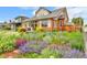 Charming brick home featuring a vibrant and colorful garden in the front yard at 2096 S Logan St, Denver, CO 80210