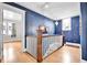 Bright hallway with hardwood floors and a decorative blue accent wall, enhancing the home's character at 2096 S Logan St, Denver, CO 80210