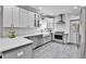Modern kitchen featuring white cabinets, stainless steel appliances, and a stylish subway tile backsplash at 2096 S Logan St, Denver, CO 80210