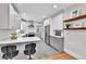Bright kitchen features quartz countertops, stainless appliances, and a breakfast bar for casual dining at 2096 S Logan St, Denver, CO 80210