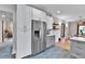 Open concept kitchen with stainless steel appliances and white cabinets at 2096 S Logan St, Denver, CO 80210