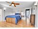 Spacious main bedroom with hardwood floors, ceiling fan, and ensuite bathroom access, creating a suite at 2096 S Logan St, Denver, CO 80210