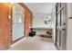 Functional mud room featuring brick walls, a hanging rack, and a built-in desk, perfect for organization and storage at 2096 S Logan St, Denver, CO 80210