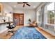 Bright and airy home office with desk, chair, and large windows overlooking the backyard at 2096 S Logan St, Denver, CO 80210