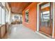 Inviting outdoor porch with brick accent wall, wood ceiling, and stylish seating area at 2096 S Logan St, Denver, CO 80210