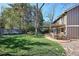 Spacious backyard featuring a covered patio, expansive lawn, and mature landscaping, ideal for outdoor enjoyment at 7866 S Valentia Way, Centennial, CO 80112