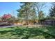 Fenced backyard features lush lawn, mature trees, and play structure, perfect for Gathering fun and outdoor activities at 7866 S Valentia Way, Centennial, CO 80112