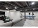 Finished basement rec area with painted ceilings, modern flooring, and living area at 7866 S Valentia Way, Centennial, CO 80112