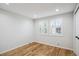 Bright bedroom with hardwood floors and a window featuring natural light at 7866 S Valentia Way, Centennial, CO 80112