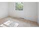 Bedroom with tan carpeting features neutral paint and natural light from a window at 7866 S Valentia Way, Centennial, CO 80112