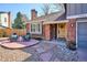 Inviting front entrance with a wooden door, brick facade, and a cozy seating area at 7866 S Valentia Way, Centennial, CO 80112