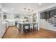 Spacious kitchen featuring a center island with seating, stainless steel appliances, and a staircase at 7866 S Valentia Way, Centennial, CO 80112
