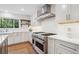Modern kitchen with white subway tile backsplash, quartz countertops, and stainless steel appliances at 7866 S Valentia Way, Centennial, CO 80112