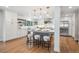 Bright kitchen boasts a large center island, stainless steel appliances, and sleek, white cabinetry at 7866 S Valentia Way, Centennial, CO 80112