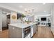 Kitchen island with a quartz countertop, stainless steel microwave, and stylish pendant lighting at 7866 S Valentia Way, Centennial, CO 80112