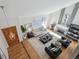 Bright open living room featuring hardwood floors, fireplace, vaulted ceiling, and modern decor at 7866 S Valentia Way, Centennial, CO 80112
