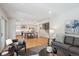Open concept living area with hardwood floors, kitchen island, and modern furnishings at 7866 S Valentia Way, Centennial, CO 80112
