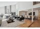 Open-concept living room with a fireplace, hardwood floors, and abundant natural light at 7866 S Valentia Way, Centennial, CO 80112