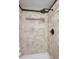 Tiled shower features large rainfall shower head and neutral coloring at 7866 S Valentia Way, Centennial, CO 80112