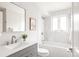 Bathroom featuring a vanity, a tub with white tile and bright natural light at 3540 Everett St, Wheat Ridge, CO 80033