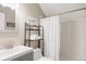 Bright bathroom featuring tiled shower, modern vanity, and stylish décor at 3540 Everett St, Wheat Ridge, CO 80033