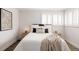 A bright bedroom showcasing a nicely decorated bed, and stylish interior at 3540 Everett St, Wheat Ridge, CO 80033
