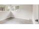 Empty bedroom with a large window, light gray wood floors, and bright white walls at 3540 Everett St, Wheat Ridge, CO 80033