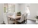 Dining area with a wooden table, chairs, and a bright window at 3540 Everett St, Wheat Ridge, CO 80033