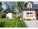 Well-maintained home exterior with a manicured lawn, storage shed, and a lovely garden area at 3540 Everett St, Wheat Ridge, CO 80033