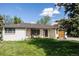 Attractive single-story home with a well-maintained lawn and a modern front door at 3540 Everett St, Wheat Ridge, CO 80033