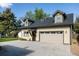 Charming home with attached garage featuring dormer windows and well-kept landscaping at 3540 Everett St, Wheat Ridge, CO 80033