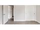Hallway featuring white painted doors, light gray wood floors, and bright neutral walls at 3540 Everett St, Wheat Ridge, CO 80033