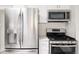Kitchen with stainless steel refrigerator, microwave, and gas range at 3540 Everett St, Wheat Ridge, CO 80033